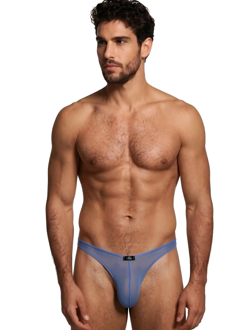 Xtremen blue mesh thong, model 92530. Low-rise, sheer fabric design. Male model wearing blue transparent thong.
