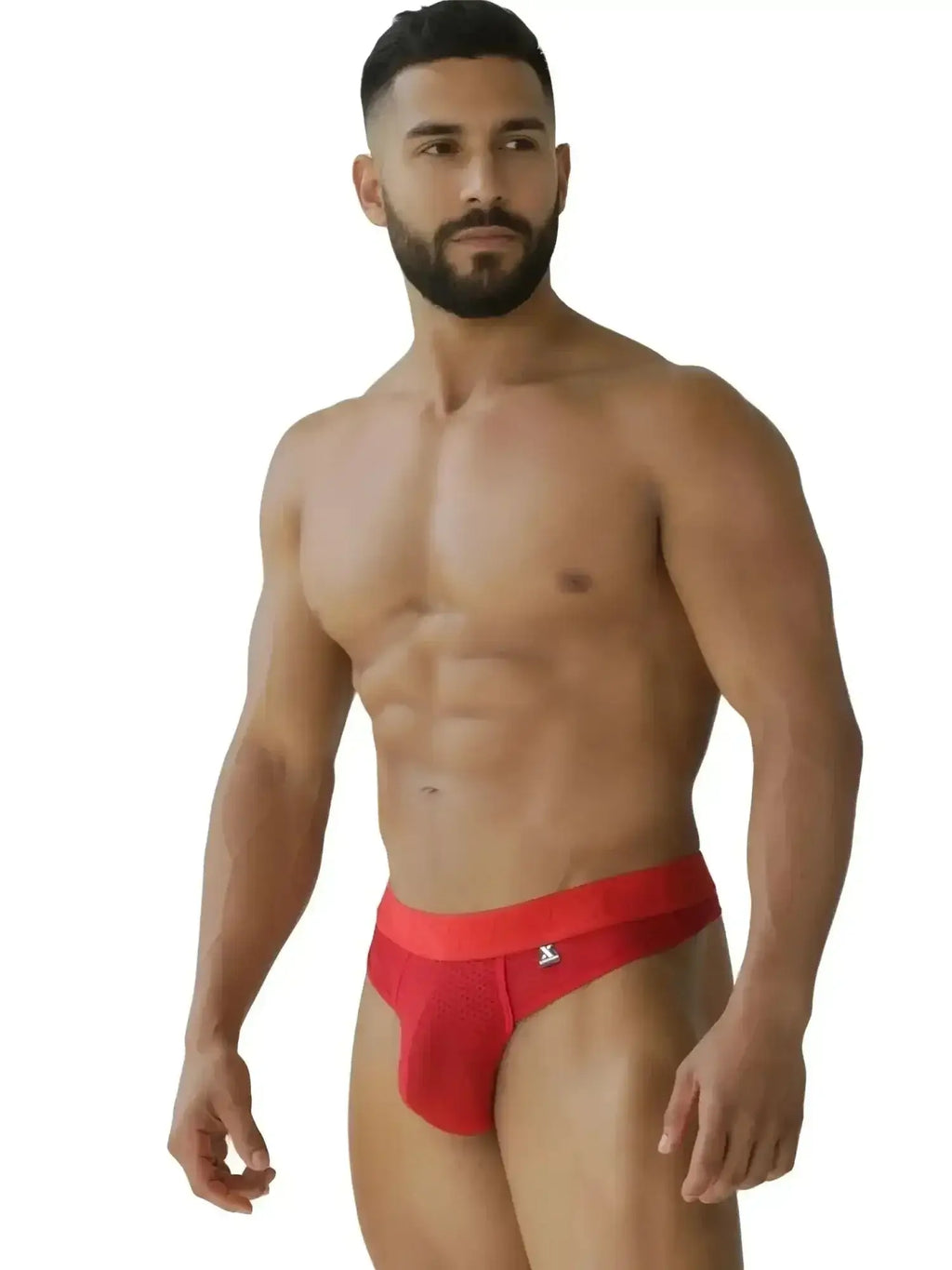 Lifestyle shot of a man wearing Xtremen 91268 red microfiber mesh thongs.