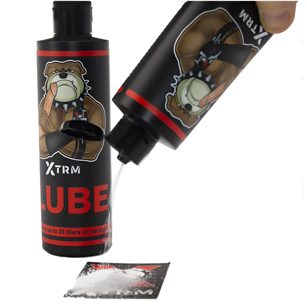 Black plastic bottle with red accents and cartoon bulldog labeled xtrm lube for 225gm powder use