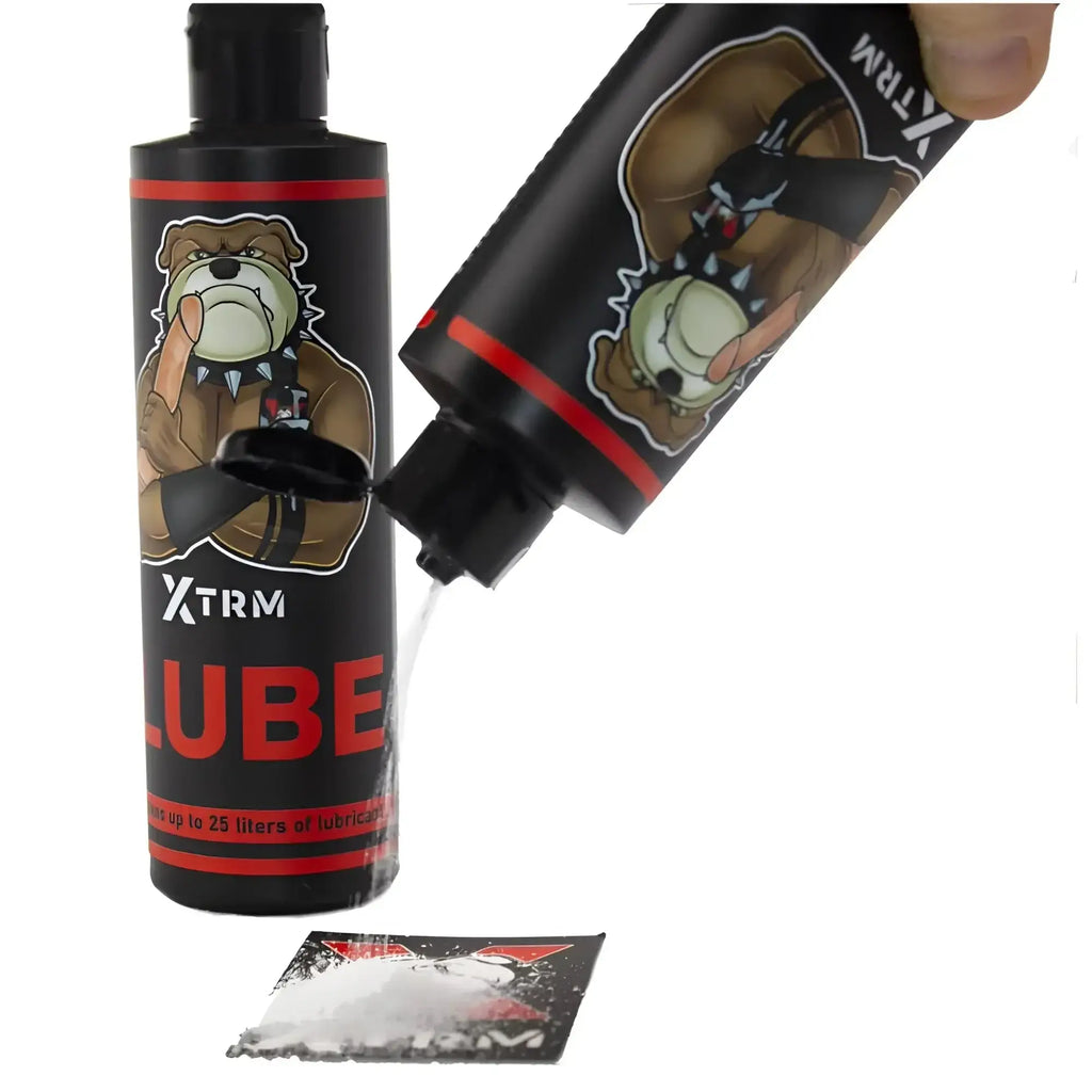 Black plastic bottle with red accents and cartoon bulldog labeled xtrm lube for 225gm powder use